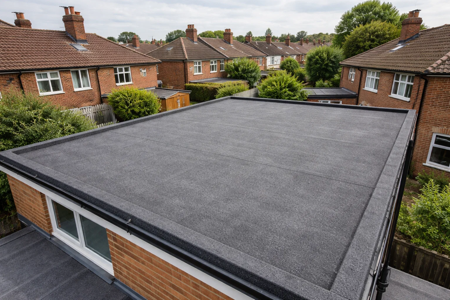 Felt flat roof on a UK residential property showing typical condition and surface detail.
